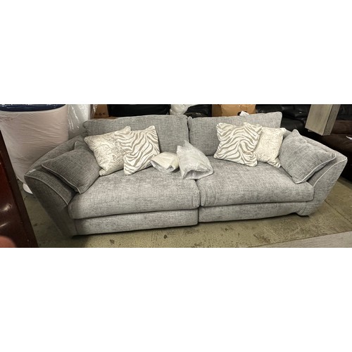 1605 - A grey textured weave upholstered four seater sofa with patterned scatter cushions