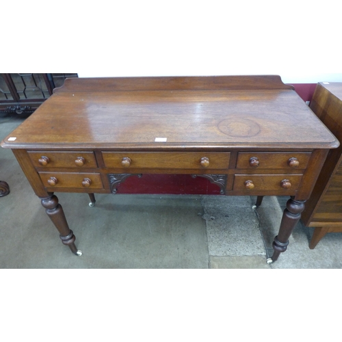 103 - A Victorian mahogany five drawer writing table