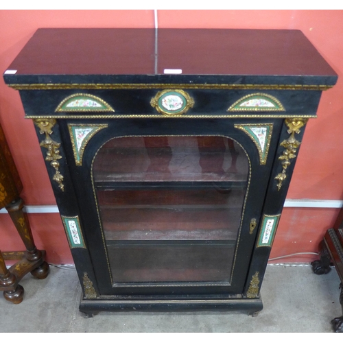 107 - A 19th Century French ebonised and gilt metal pier cabinet, mounted with Sevres style painted porcel... 