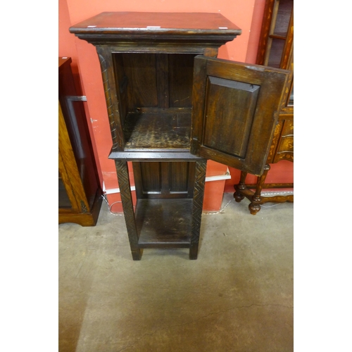 109 - An Elizabethan Revival carved oak cabinet on stand