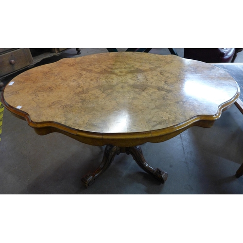 112 - A Victorian figured walnut serpentine tilt-top loo table