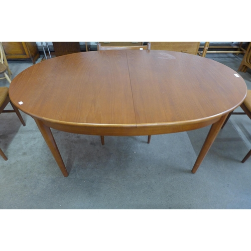 14 - A teak extending dining table and four chairs