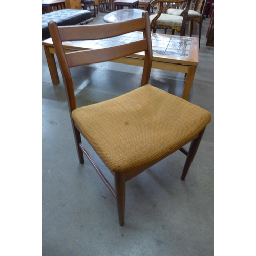 14 - A teak extending dining table and four chairs