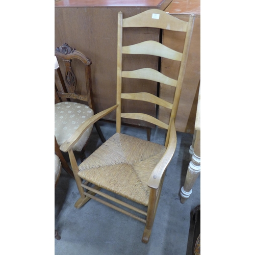 164 - An Arts and Crafts Ernest Gimson style ash and rush seated rocking chair