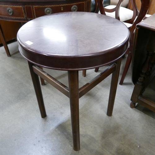 189 - An elm and Bakelite circular occasional table