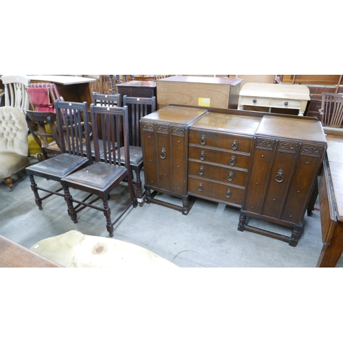 214 - A carved oak sideboard and four dining chairs