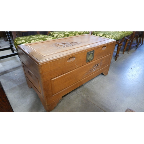 217 - An oriental carved camphorwood blanket box