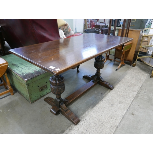 235 - A carved oak refectory table and a dresser