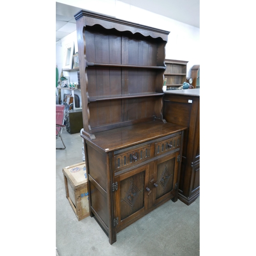 235 - A carved oak refectory table and a dresser