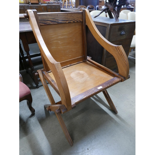 260 - A Gothic Revival pitch pine and beech Glastonbury chair