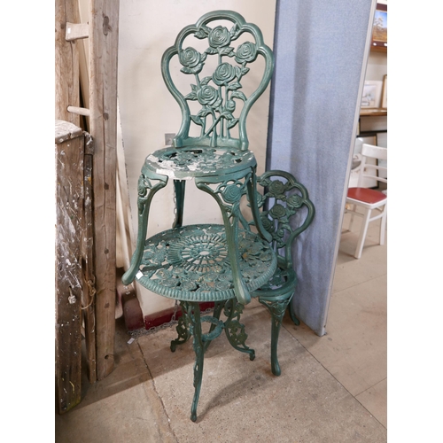 270 - A cast alloy garden table and two chairs