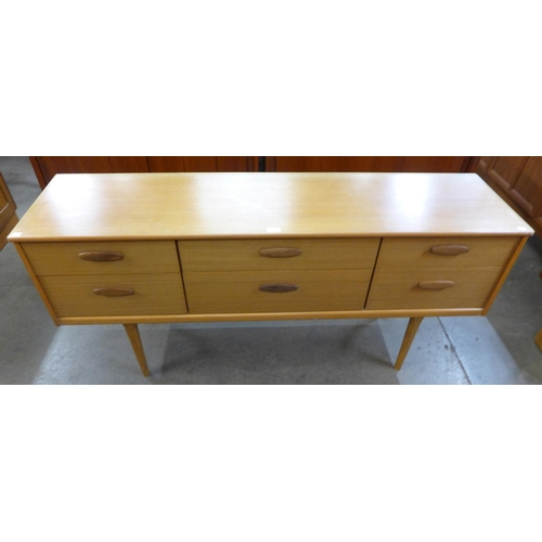 37 - An Austin Suite teak six drawer sideboard