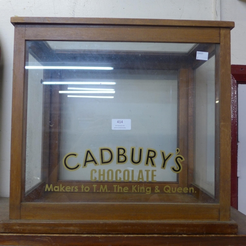 414 - A glazed mahogany counter top shop cabinet, bearing Cadbury's Chocolate inscription