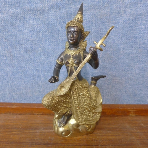 416 - A small Thai gilt bronze figure of a musician