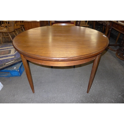 56 - A G-Plan Fresco teak circular extending dining table and two teak dining chairs