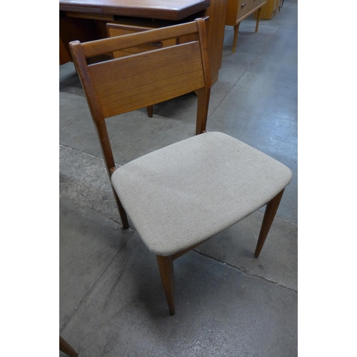 64 - A set of four teak dining chairs