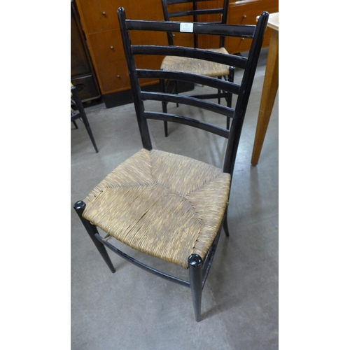 77 - A set of three Italian ebonised and rush seated chairs, designed by Otto Gerdau for the Rooksmoor Mi... 