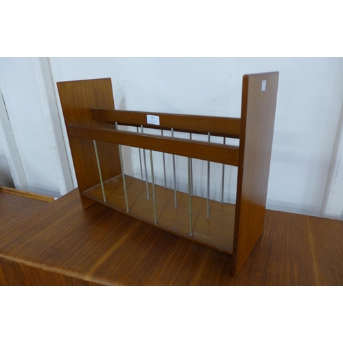 83 - A teak framed mirror and teak magazine rack