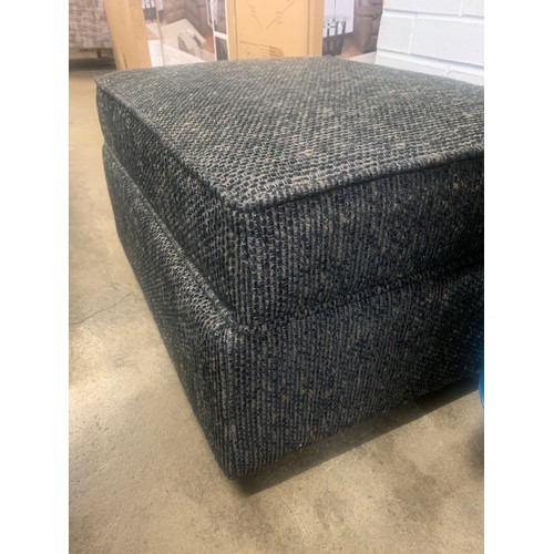 1340 - A black flecked textured weave upholstered ottoman footstool RRP £459, damage to hinge