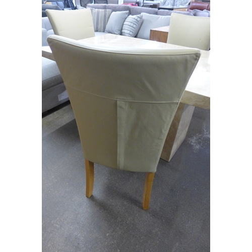 1999 - A cream marble effect dining table with a set of four cream leather dining chairs