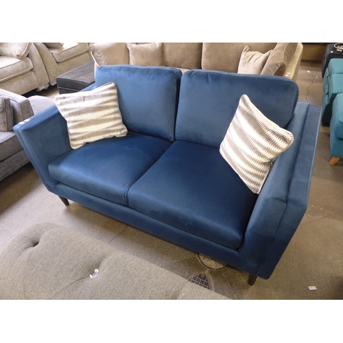 1303 - A navy blue upholstered two seater sofa with patterned scatter cushions