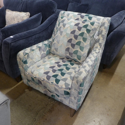 1400 - A cream, teal and grey patterned upholstered armchair