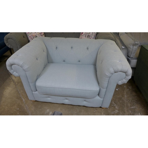 1403 - A light grey textured weave Chesterfield style love seat