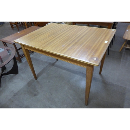 77 - A Gordon Russell walnut extending dining table