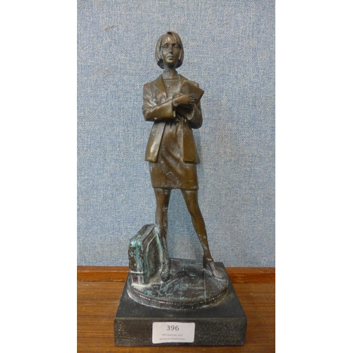 354 - A bronze figure of a female office worker