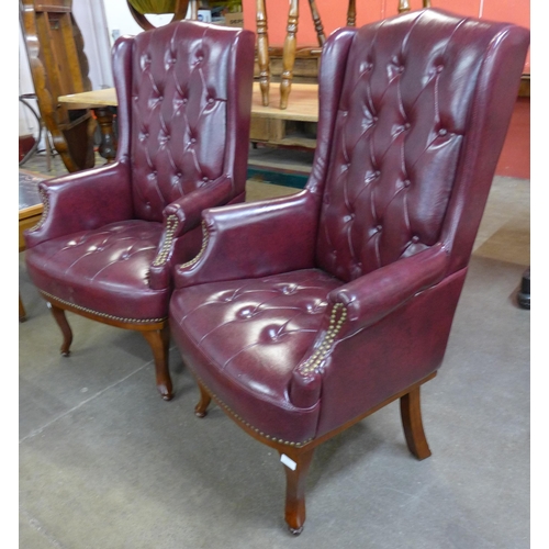 114A - A pair of Queen Anne style faux burgundy leather wingback armchairs