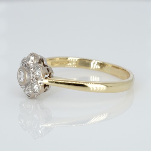 1051 - An 18ct gold and diamond cluster ring, 0.33ct diamond weight marked on the shank, ring size R½, weig... 