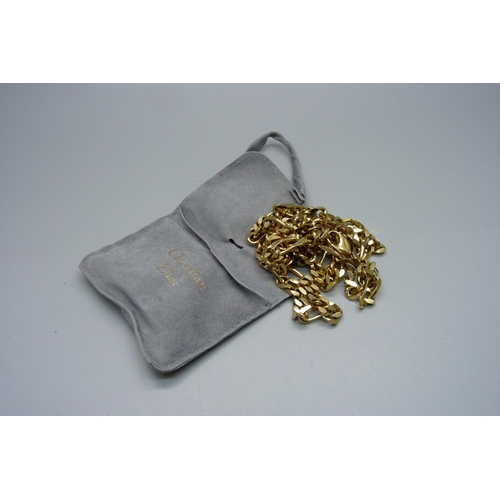 1006 - A long Christian Dior gold tone Figaro chain necklace, 86cm, with bag