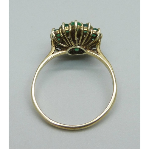 1011 - A 9ct gold, emerald and diamond cluster ring, 13 emeralds and 6 diamonds, R, 2.9g, Birmingham 1988