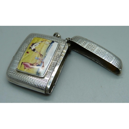 1028 - A silver vesta case with applied plaque with tennis scene, engine turned case, Birmingham 1906, 35g