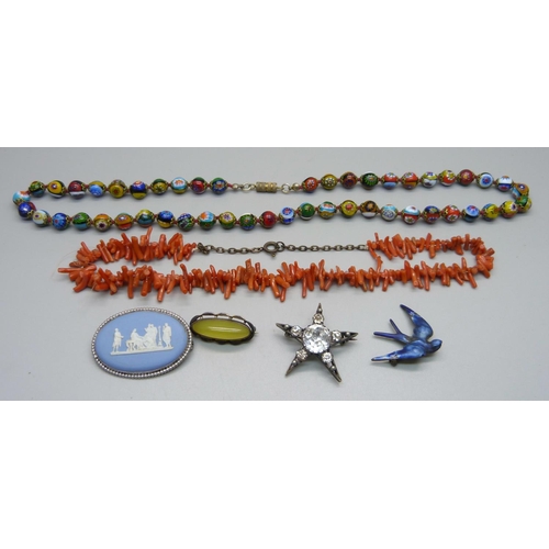 1045 - Three silver and silver mounted brooches, a paste star brooch, a coral necklace and a millefiori nec... 