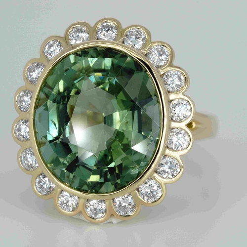 1048 - An 18ct yellow gold, 11.82ct oval cut green tourmaline and diamond ring, 1.14ct diamond weight marke... 