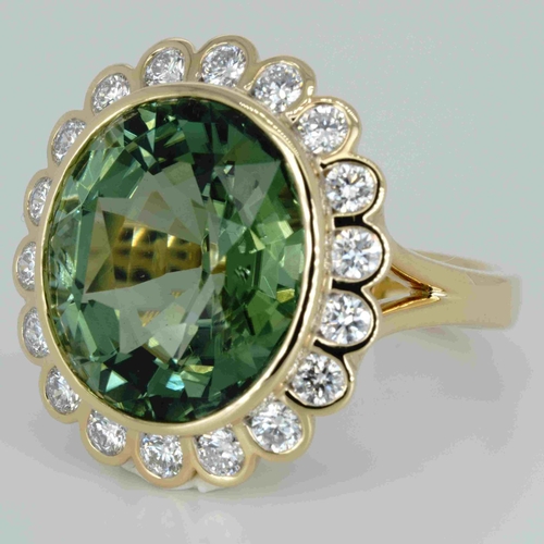 1048 - An 18ct yellow gold, 11.82ct oval cut green tourmaline and diamond ring, 1.14ct diamond weight marke... 