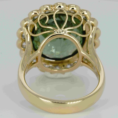 1048 - An 18ct yellow gold, 11.82ct oval cut green tourmaline and diamond ring, 1.14ct diamond weight marke... 