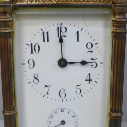 614 - An early 20th Century brass and four glass sided carriage clock with alarm