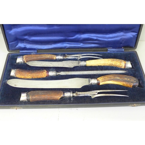 674 - An antler handled carving set, cased