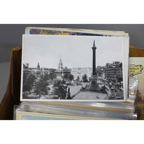 687 - A box of London and suburbs postcards with an album of 200 cards and a similar number loose