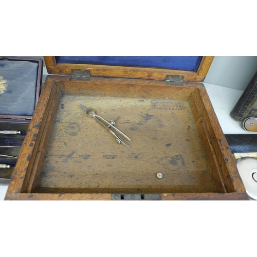 696 - A box containing old rulers and drawing instruments