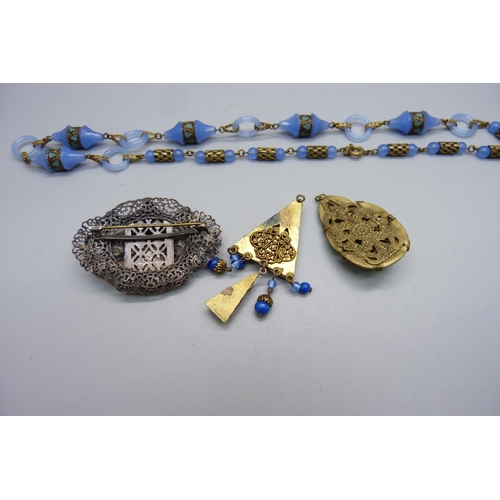 1000 - A Czech brooch, possibly by Neiger Brothers, a blue glass necklace and two pendants