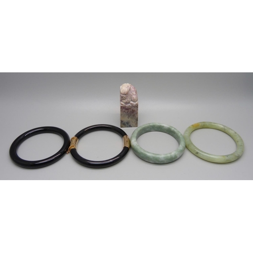 1004 - A Chinese seal and four bangles, jadeite and onyx