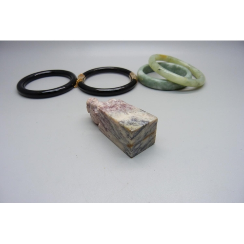 1004 - A Chinese seal and four bangles, jadeite and onyx