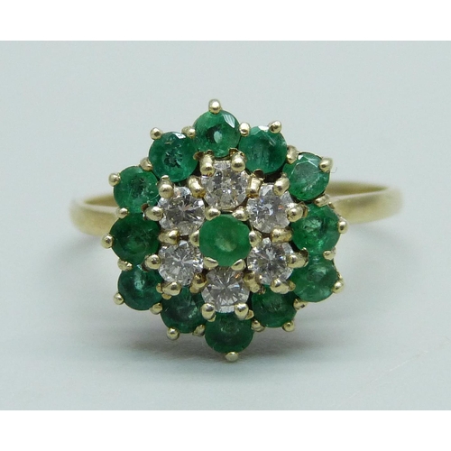 1011 - A 9ct gold, emerald and diamond cluster ring, 13 emeralds and 6 diamonds, R, 2.9g, Birmingham 1988