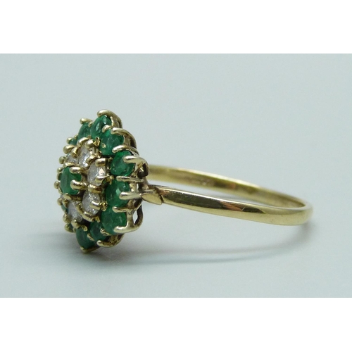 1011 - A 9ct gold, emerald and diamond cluster ring, 13 emeralds and 6 diamonds, R, 2.9g, Birmingham 1988