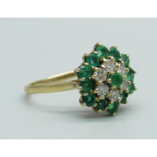 1011 - A 9ct gold, emerald and diamond cluster ring, 13 emeralds and 6 diamonds, R, 2.9g, Birmingham 1988