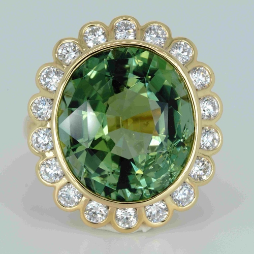 1048 - An 18ct yellow gold, 11.82ct oval cut green tourmaline and diamond ring, 1.14ct diamond weight marke... 