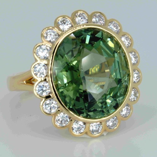 1048 - An 18ct yellow gold, 11.82ct oval cut green tourmaline and diamond ring, 1.14ct diamond weight marke... 